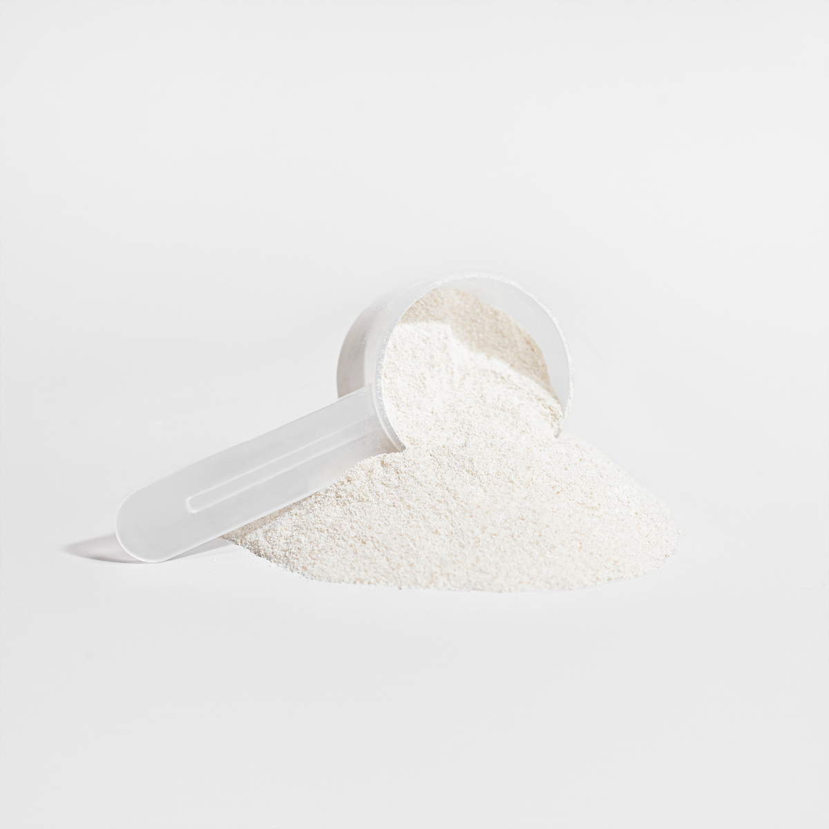Scoop and mound of vanilla Grass-Fed Collagen Creamer powder